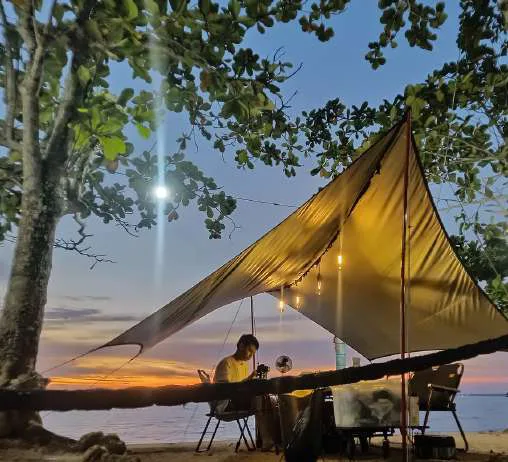 Khaki flysheet with pull lamps at sunset