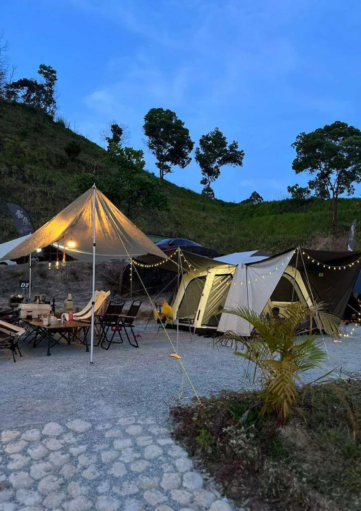 Tent Owlet campsite at dusk with auto tents, flysheet and fairy lights